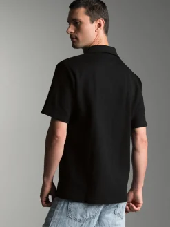 Oversized Poloshirt ohne Knopfleiste in Waffeloptik Schwarz